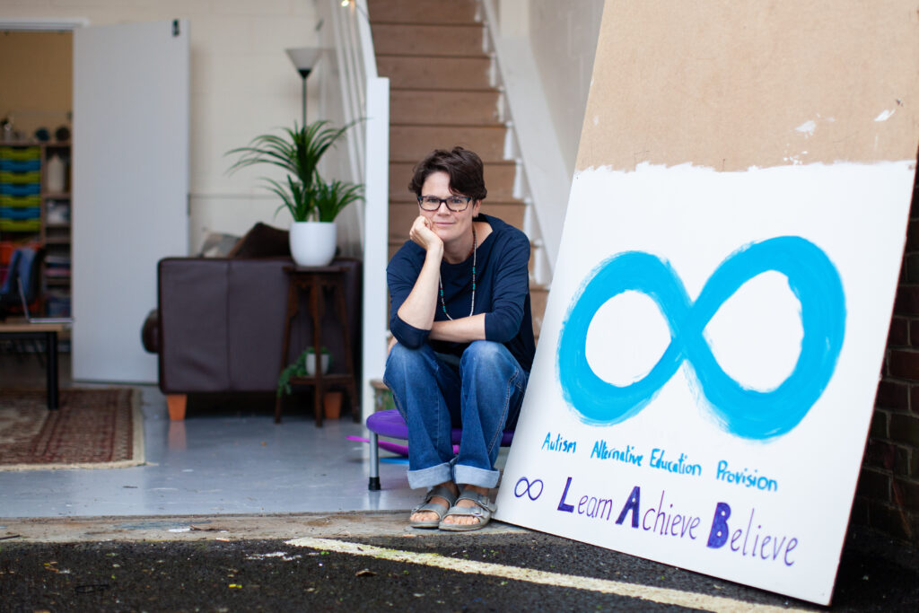 Dee Nic Stiric, Founder of Autism Champions, in their new unit with a LAB sign next to her