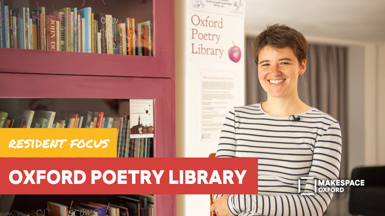 Phoebe sits in front of the poetry library shelves smiling to camera with text reading 'Resident Focus: Oxford Poetry Library'