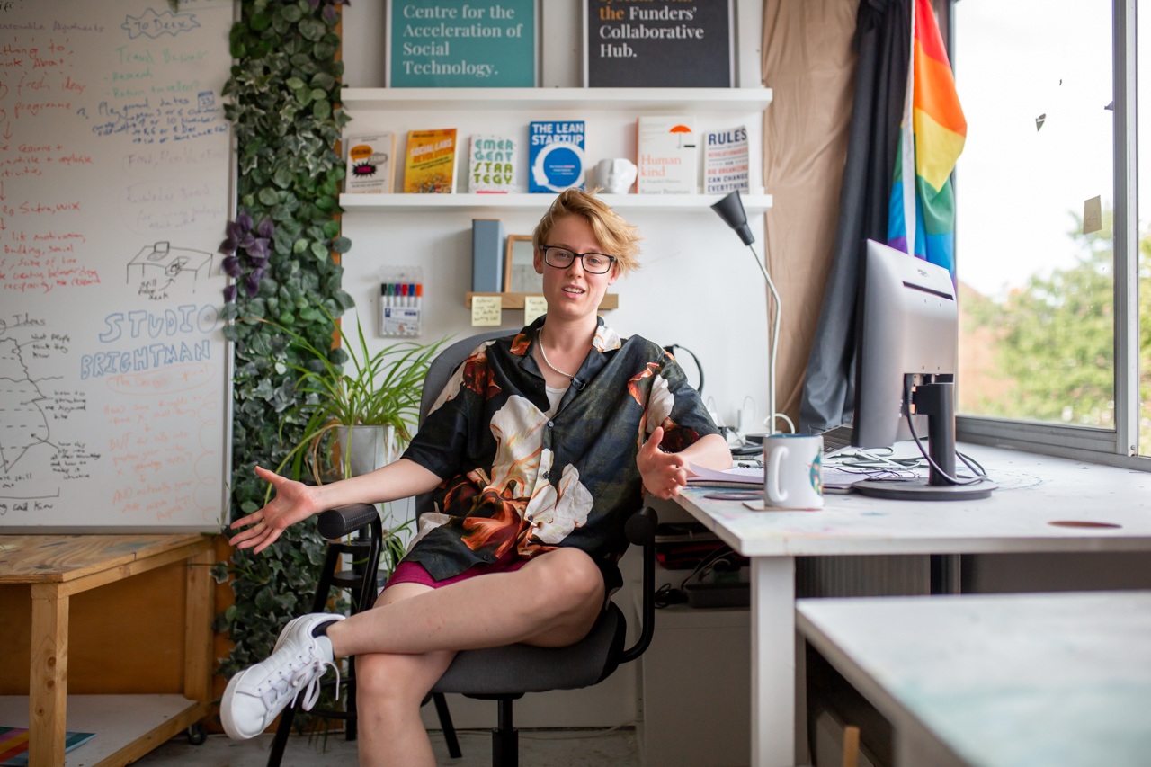 Person sits at desk in artist studio space