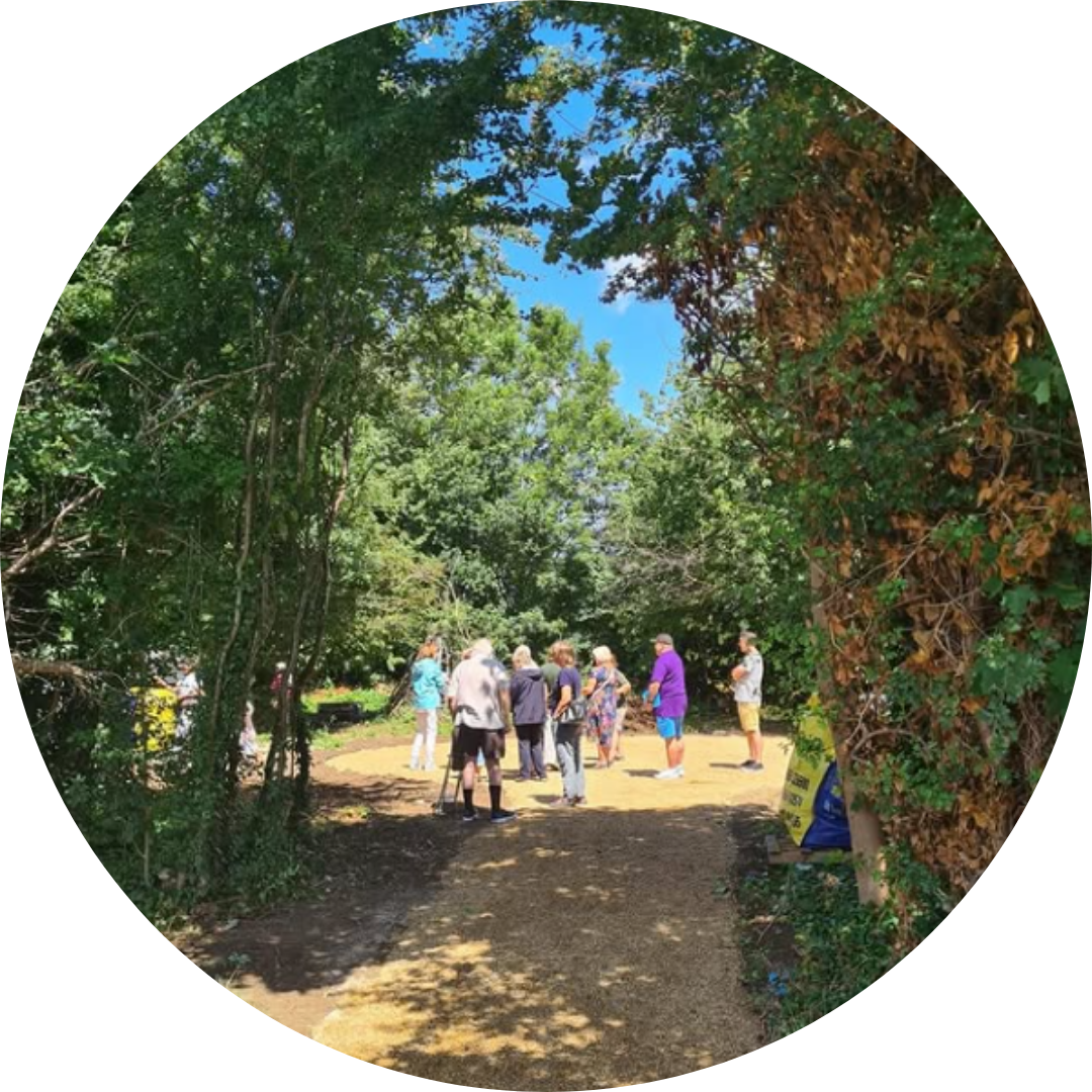 Small circular photo showing community garden in sunlight