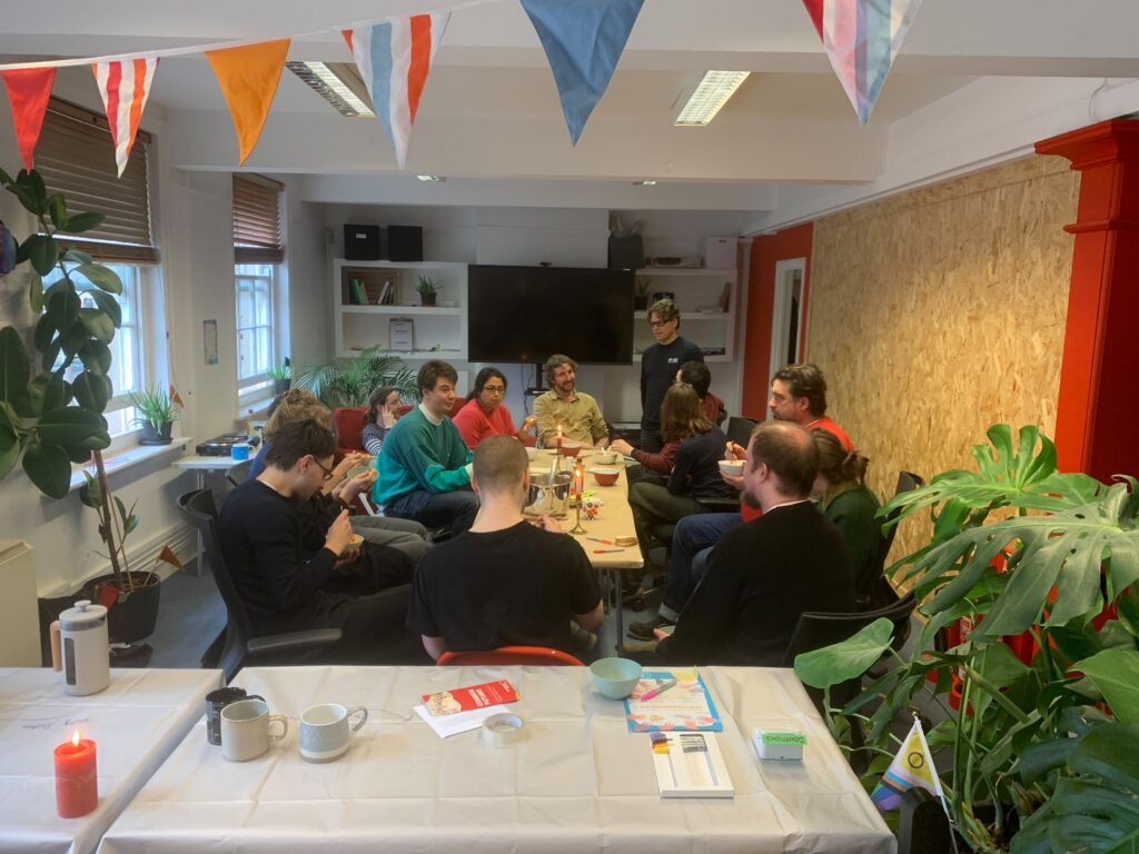 A group of Makespace residents enjoying lunch together in a common room