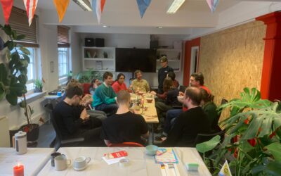 A group of Makespace residents enjoying lunch together in a common room