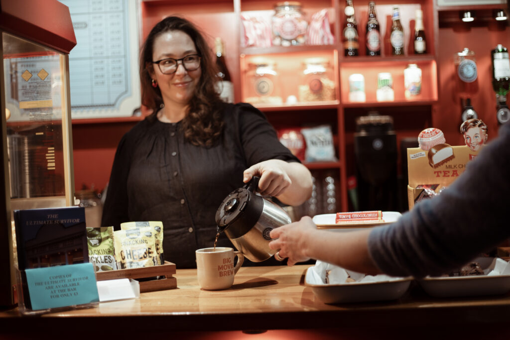 Micaela Tuckwell working behind the bar in the UPP, pouring coffee for an unseen guest